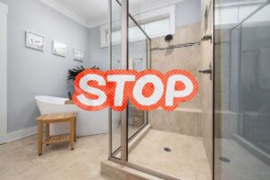 bagno con box doccia e scritta stop